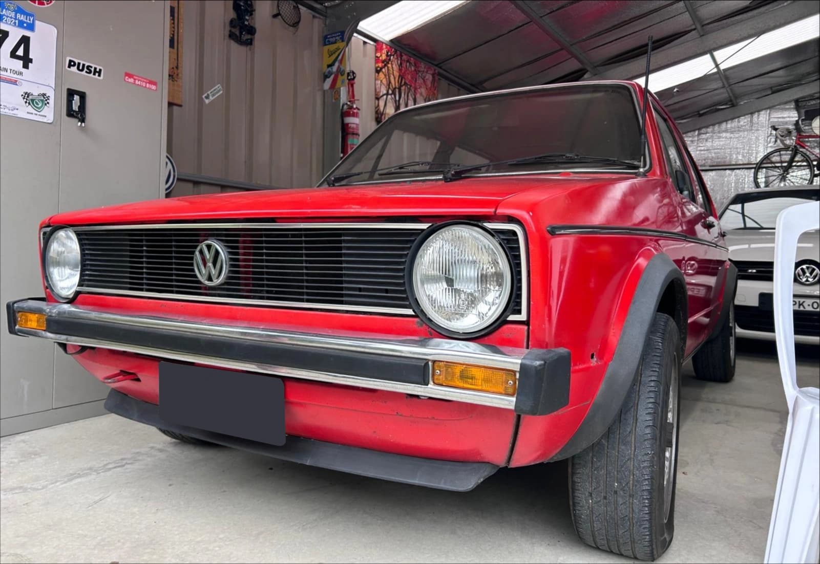 Red Volkswagen photographed inside Jai's Auto Garage